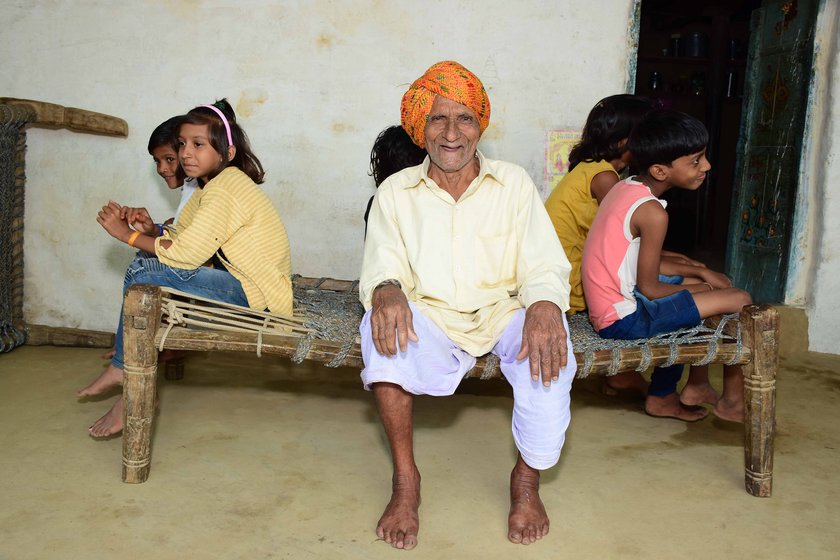 Left: Sukhlal Suliya with his family (left to right): son Badri, Badri's sons Deepak and Vijay, and Badri's wife Devaki. Right: With a few of his 17 grandchildren