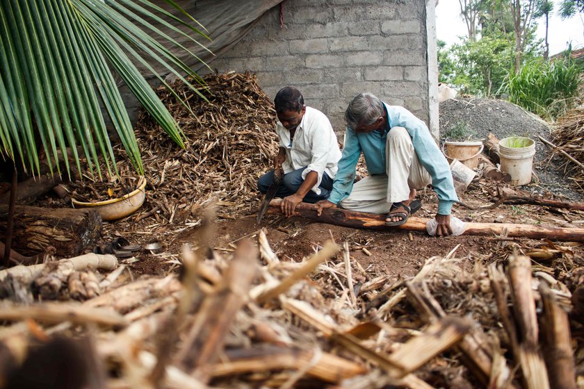 Ashok Bhosale cuts off the excess wood to maintain a uniform shape.