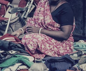 Woman trading clothes for utensils