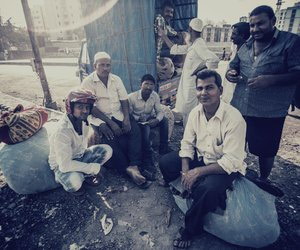 Group of men with sacks of clothes