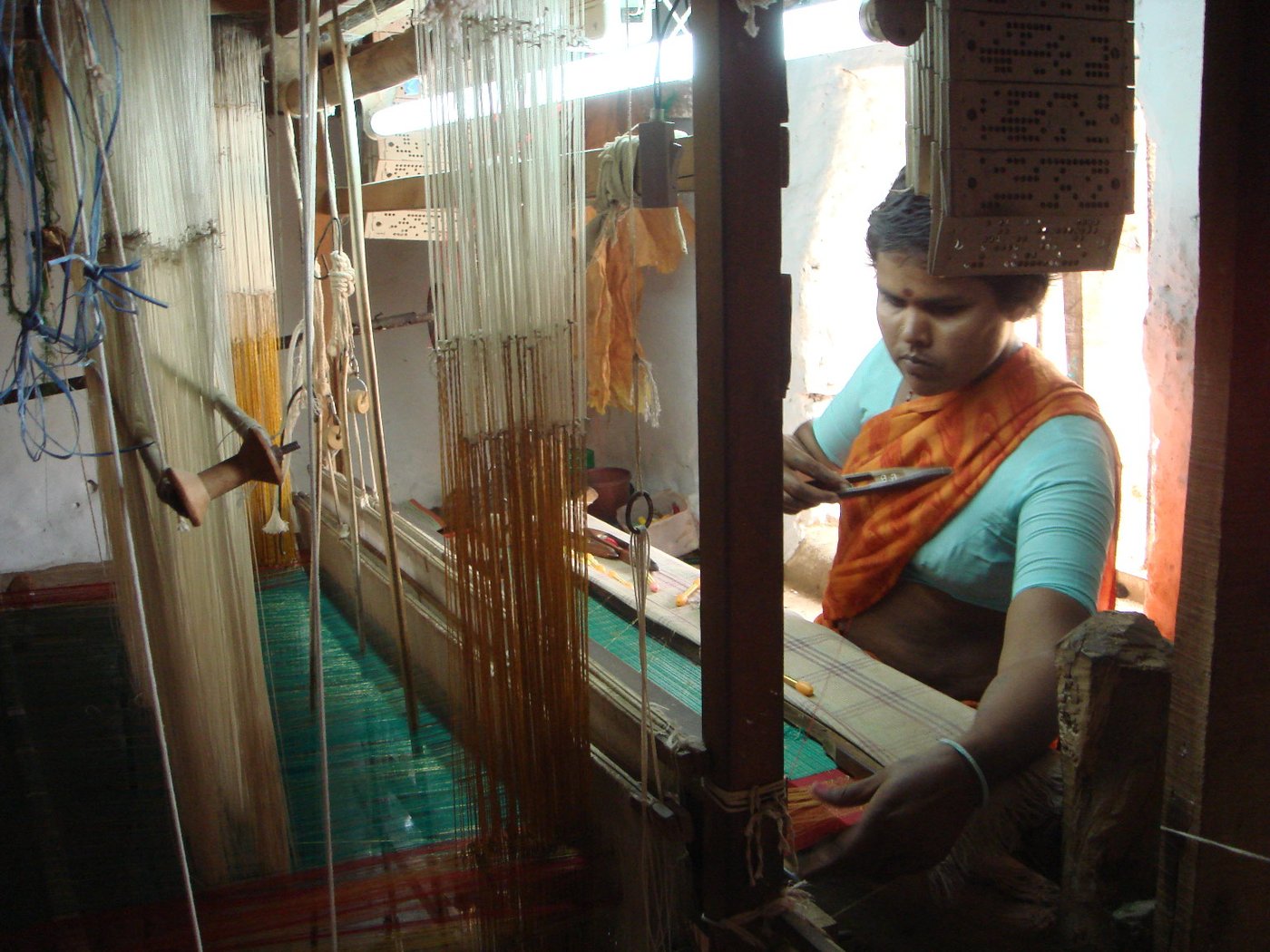Woman weaving saree on handloom