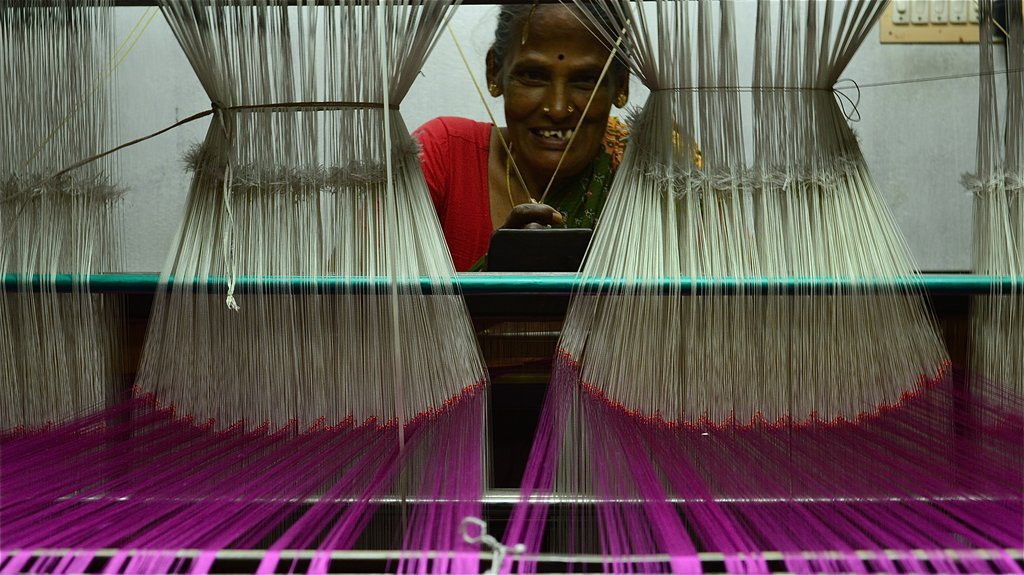 Woman weaving saree on handloom