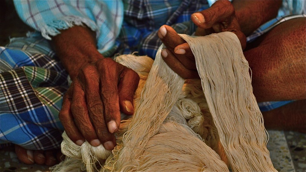 Man holding cotton thread