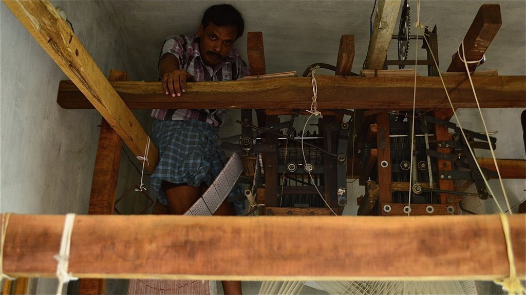 Man in front of handloom