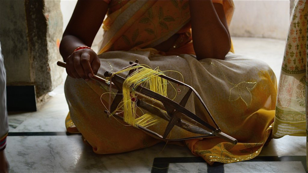 Woman adding thread to spindle
