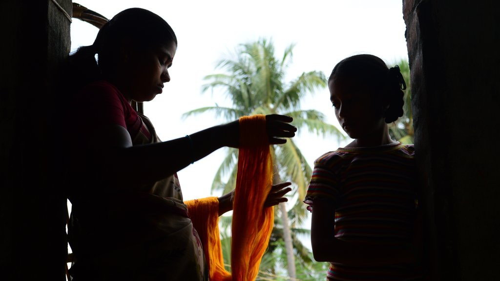 Two women with silk yarn