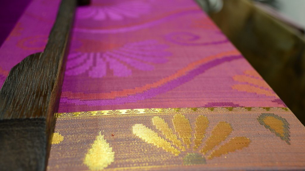 Saree being rolled out on handloom