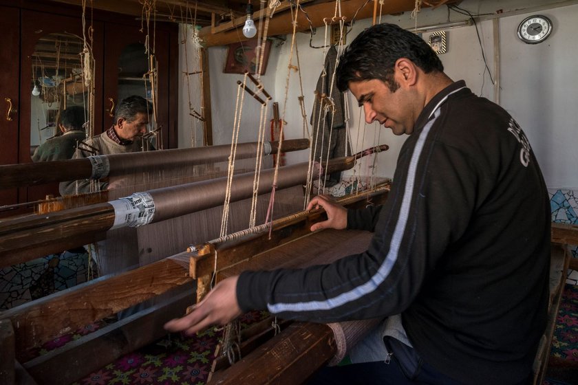 Mohammed Sidiq Kotha and his son Irshad Ahmed Kotha have been hand-weaving pashmina shawls  on the charka for decades. They that the speed of machine-woven shawls is hard to compete with 