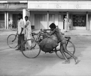 Young boy pushing coal on a cycle