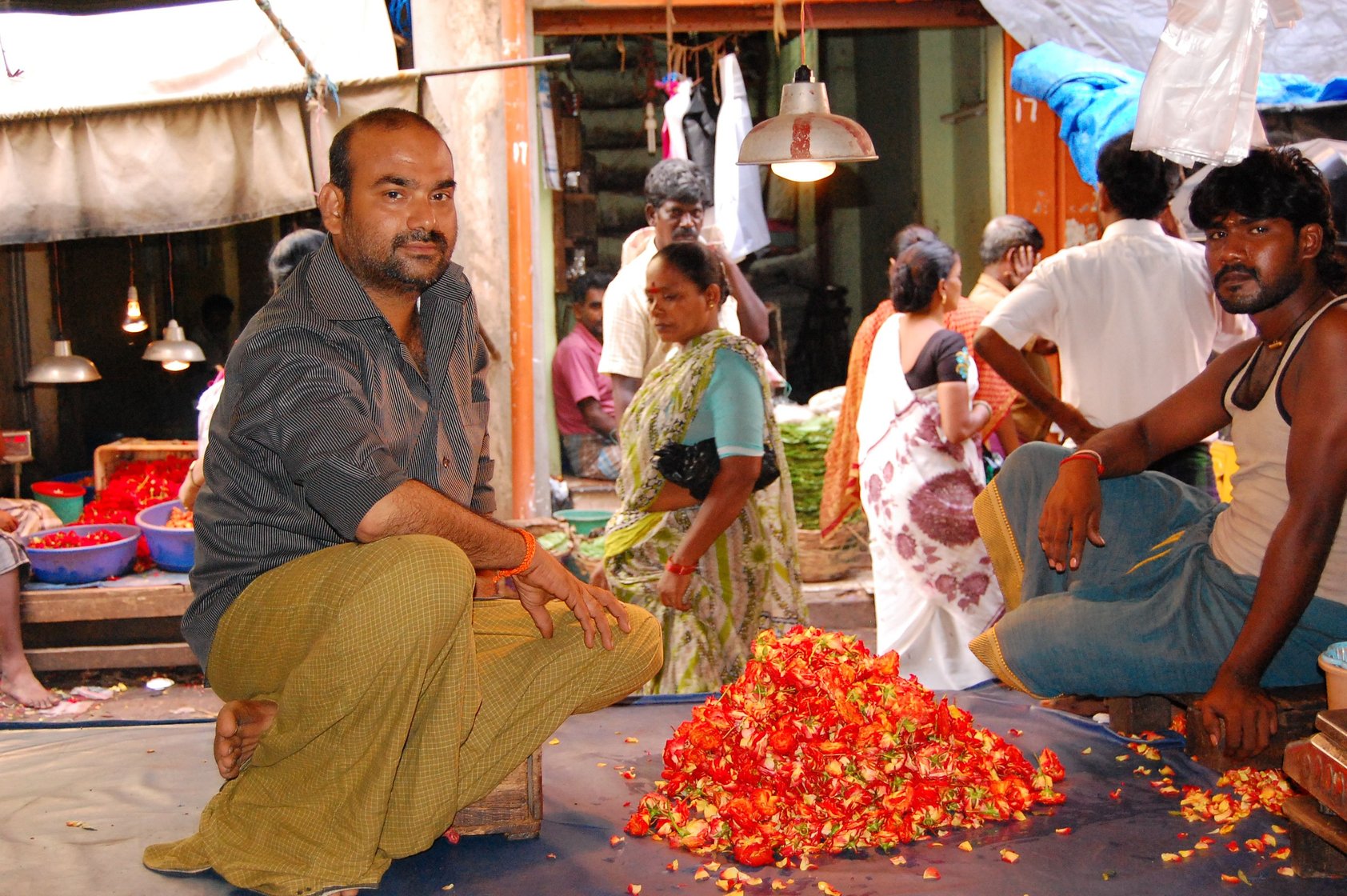 A man sits by his flower stall