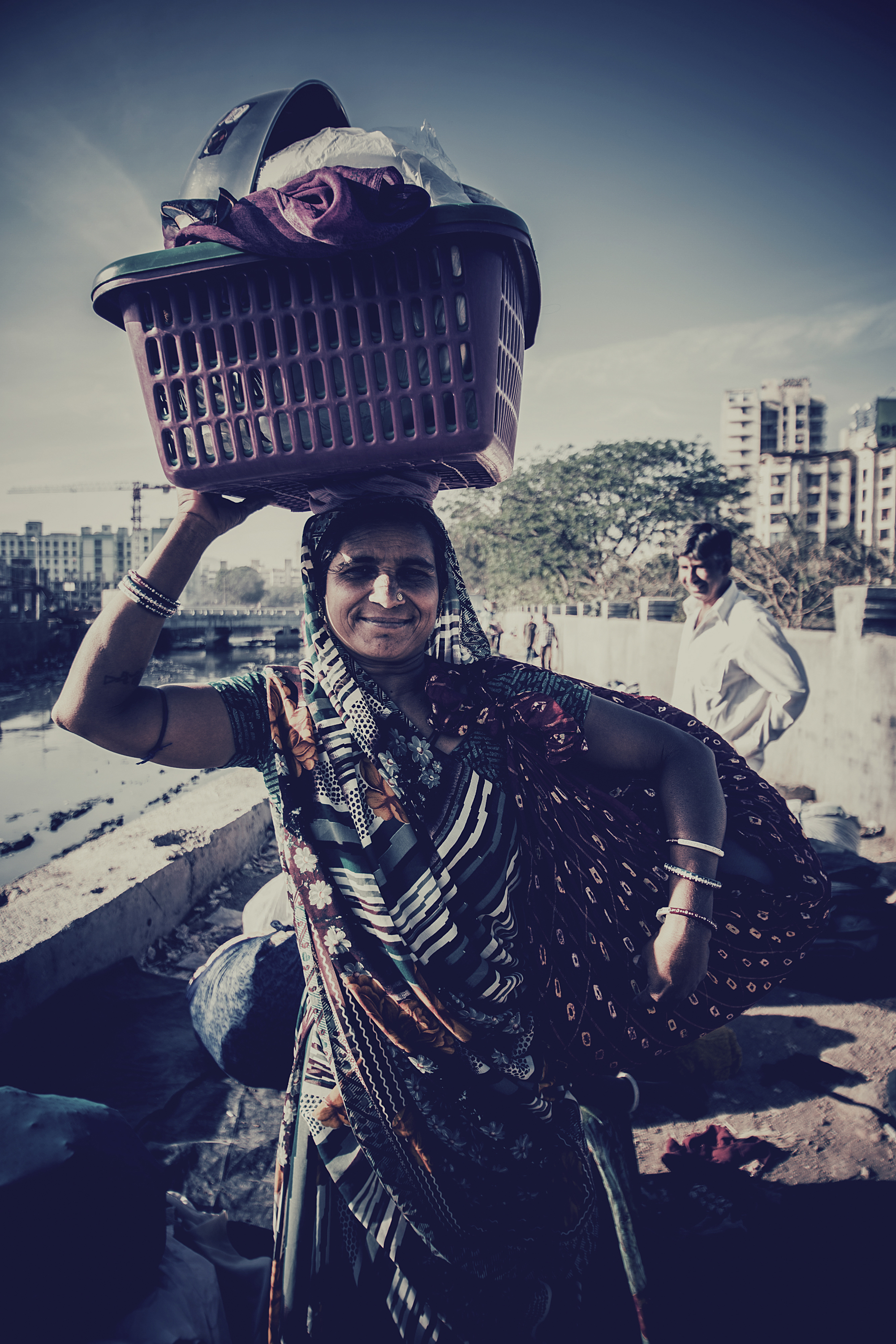 Woman carrying basket full of utensils